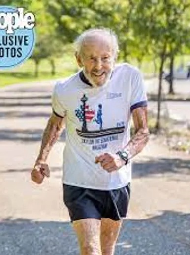 An Older Man Participating in a Race, Focused and Determined as He Runs Along the Track.